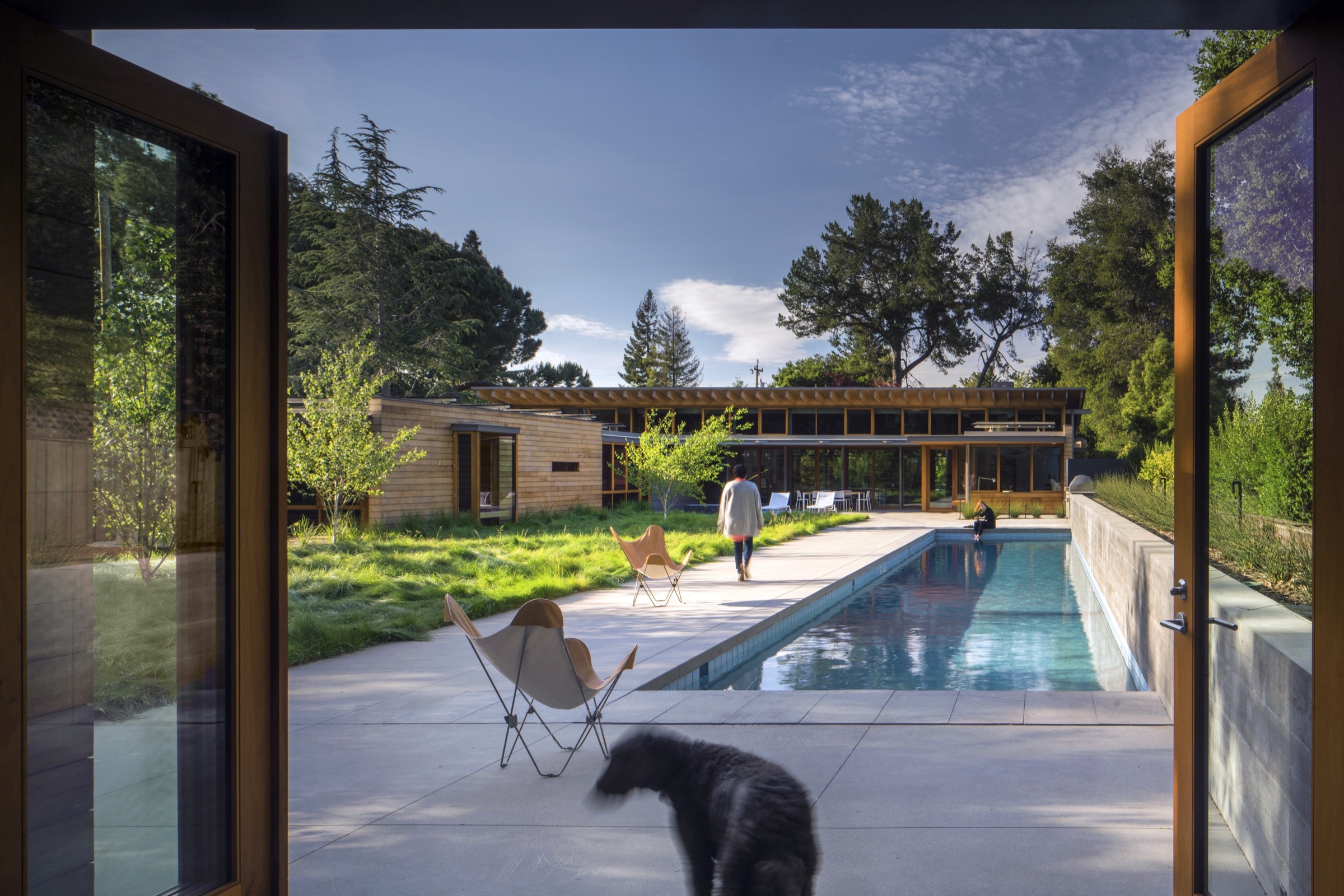 Pool and timber residence viewed from guest accommodation