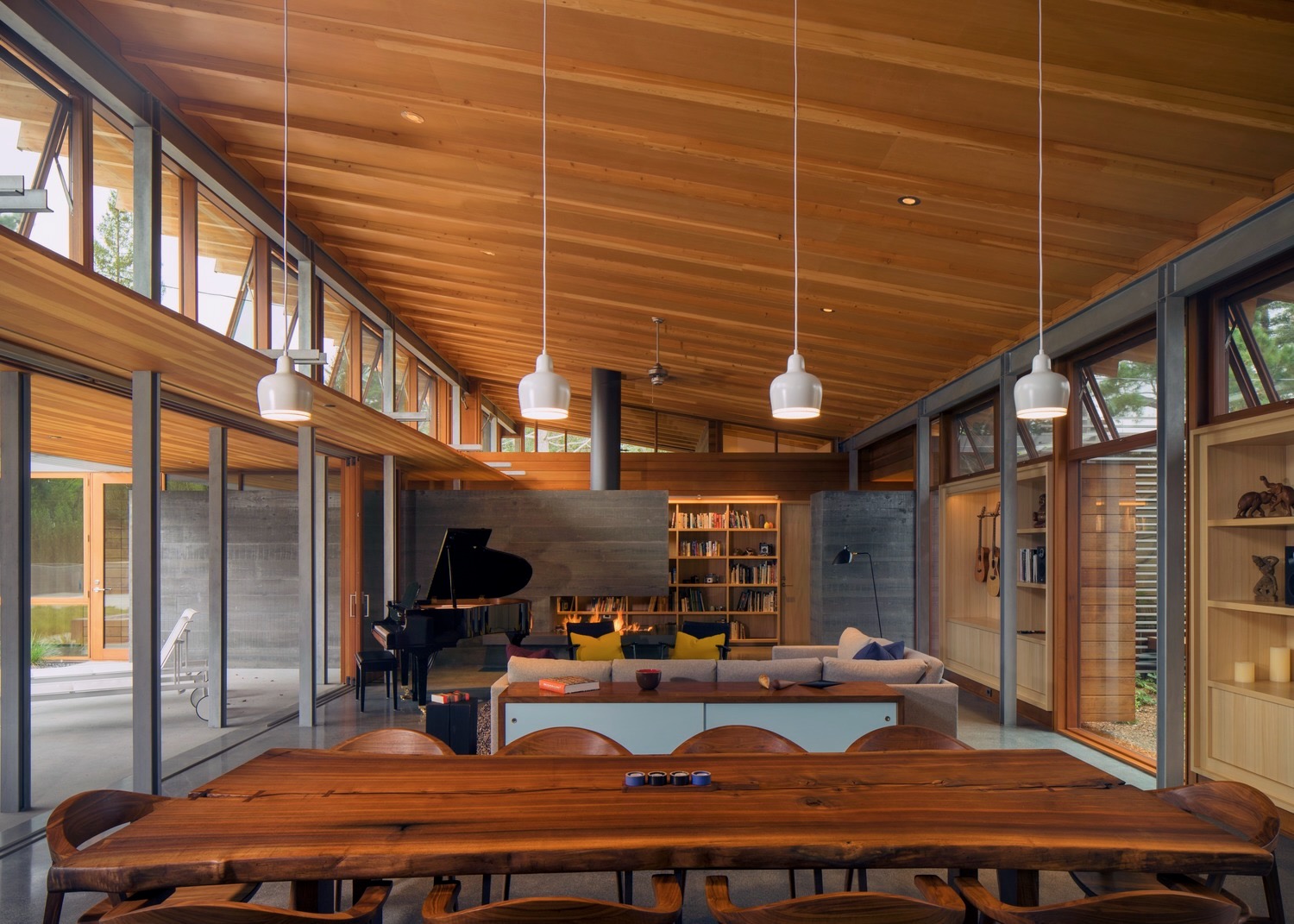 Warm timber dining and living room with fireplace