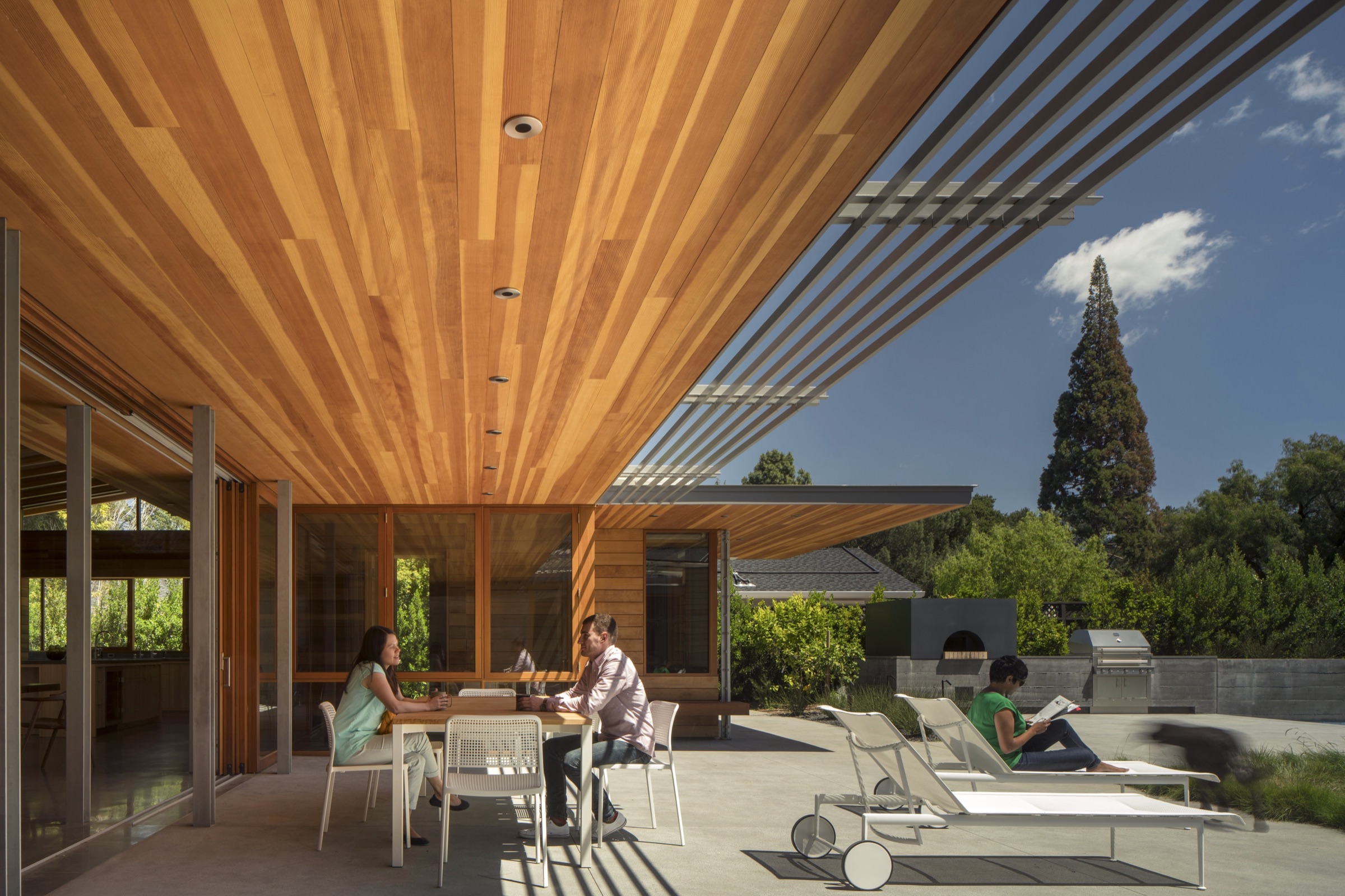 Deep timber veranda with outdoor dining and sun loungers